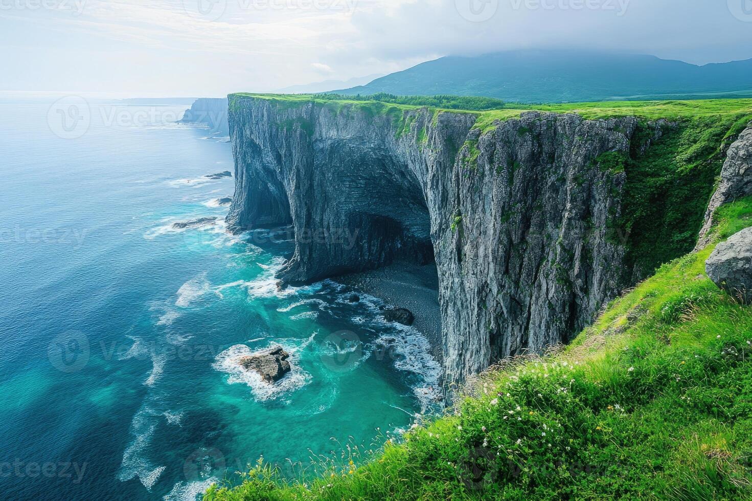 Ocean waves crashing against dramatic cliffs in hokkaido, japan photo