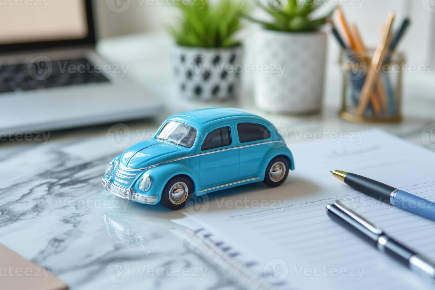 Blue miniature car on desk symbolizing auto insurance or purchase photo