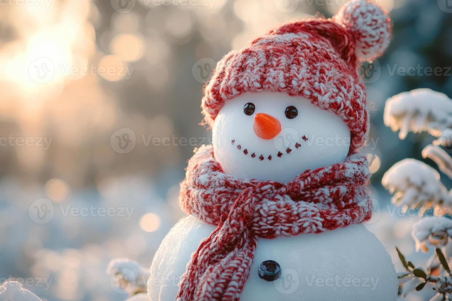 Snowman wearing red knitted scarf and hat enjoying winter sunset photo