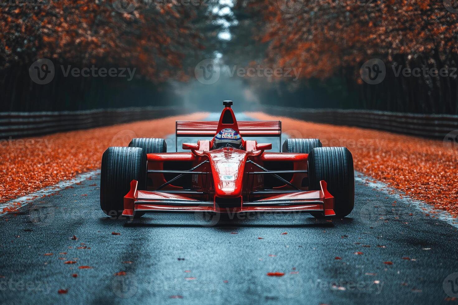 Red formula one car standing on a racetrack in autumn photo