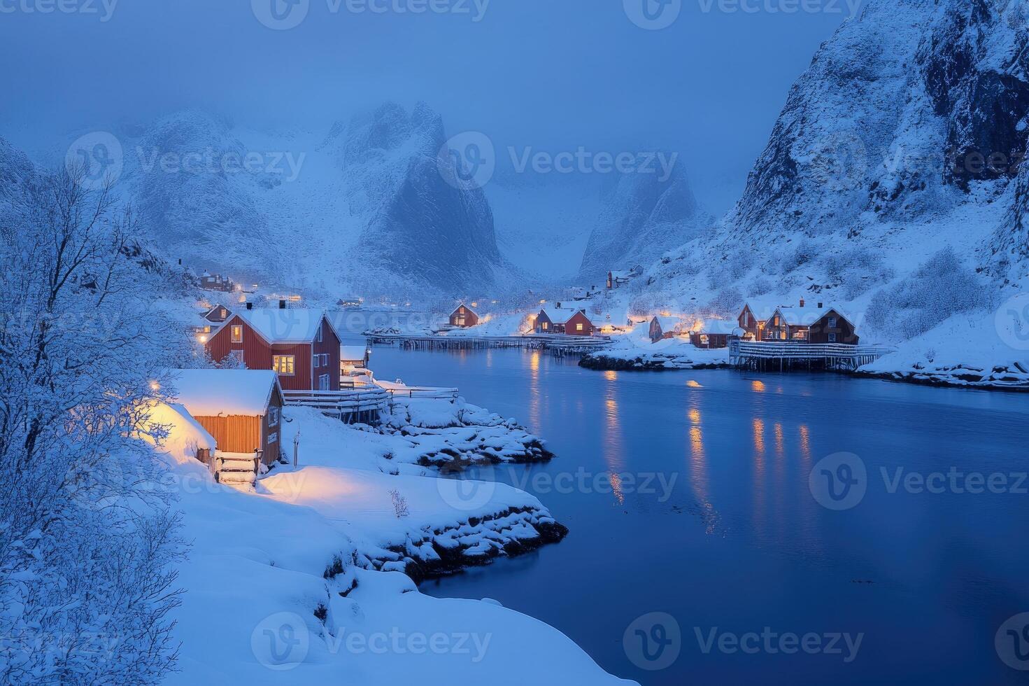 Traditional red rorbu houses illuminating a snowy evening in lofoten, norway photo