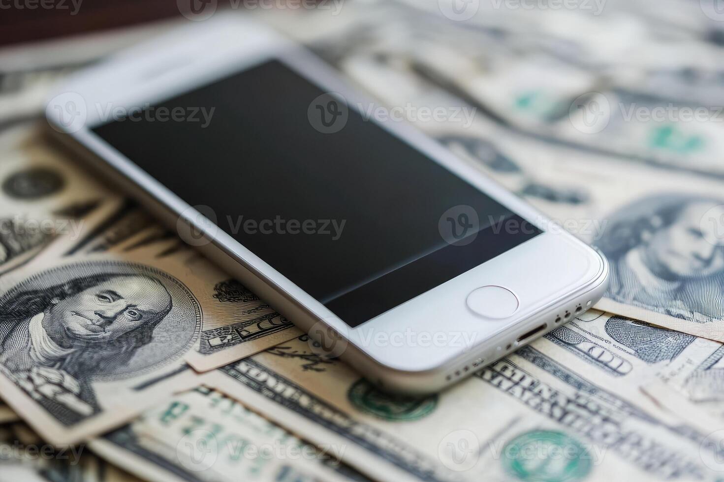 Modern smartphone lying on hundreds of us dollar bills photo