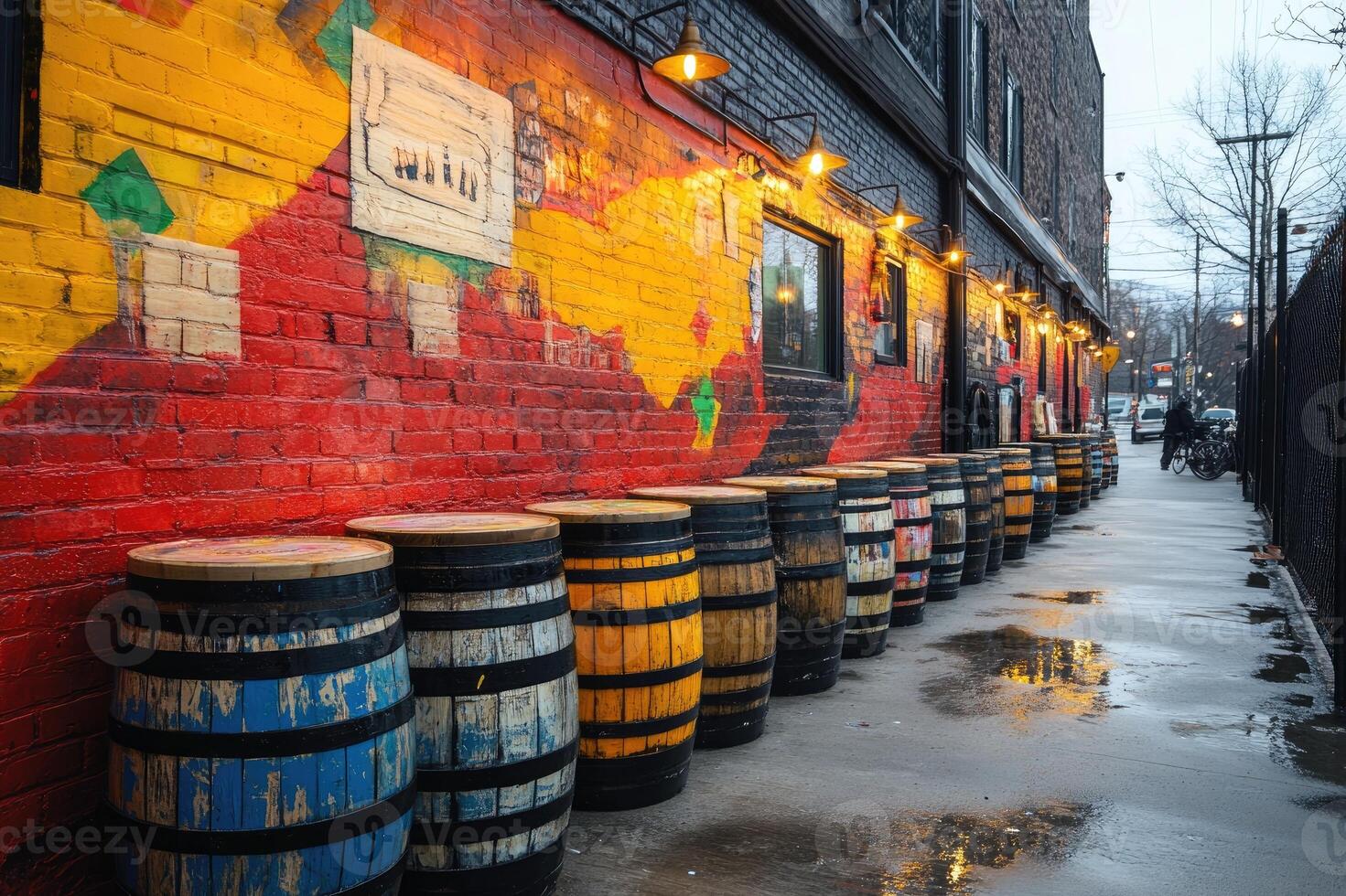 Colorful barrels lining a city sidewalk photo