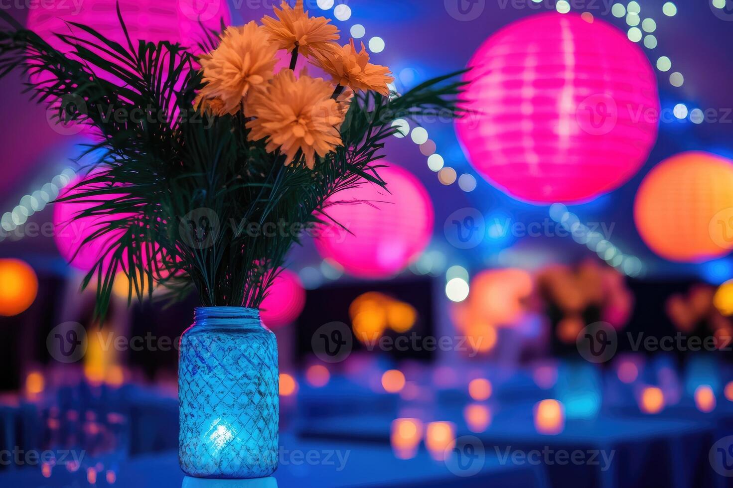Yellow flowers in blue vase illuminating a party in the background photo