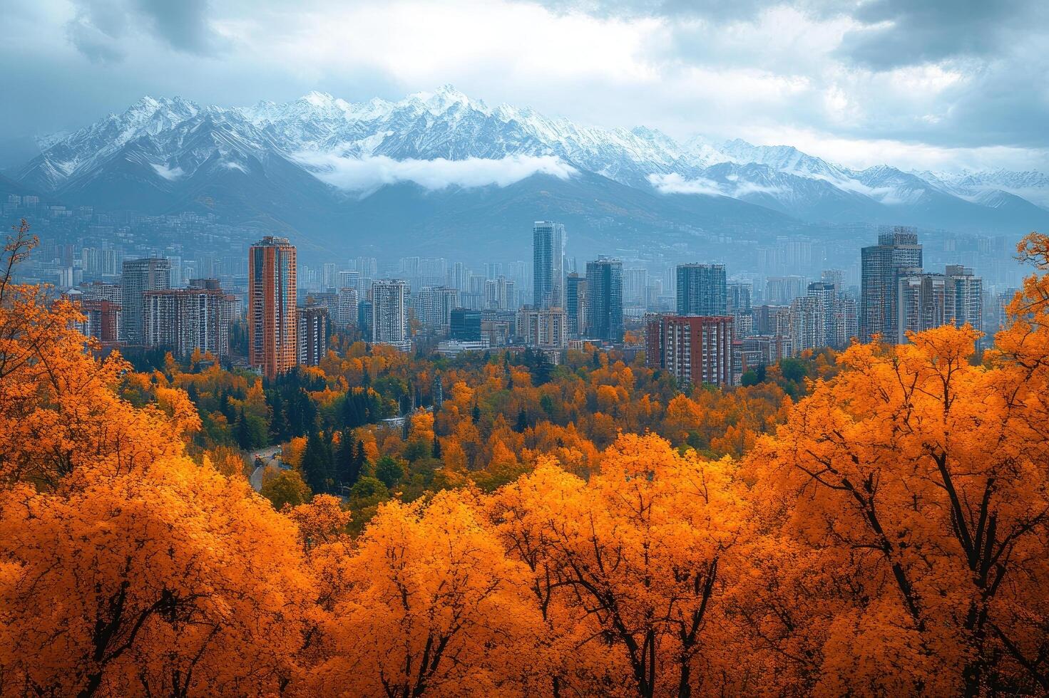 Almaty city skyline rising above autumn trees and snow capped mountains photo