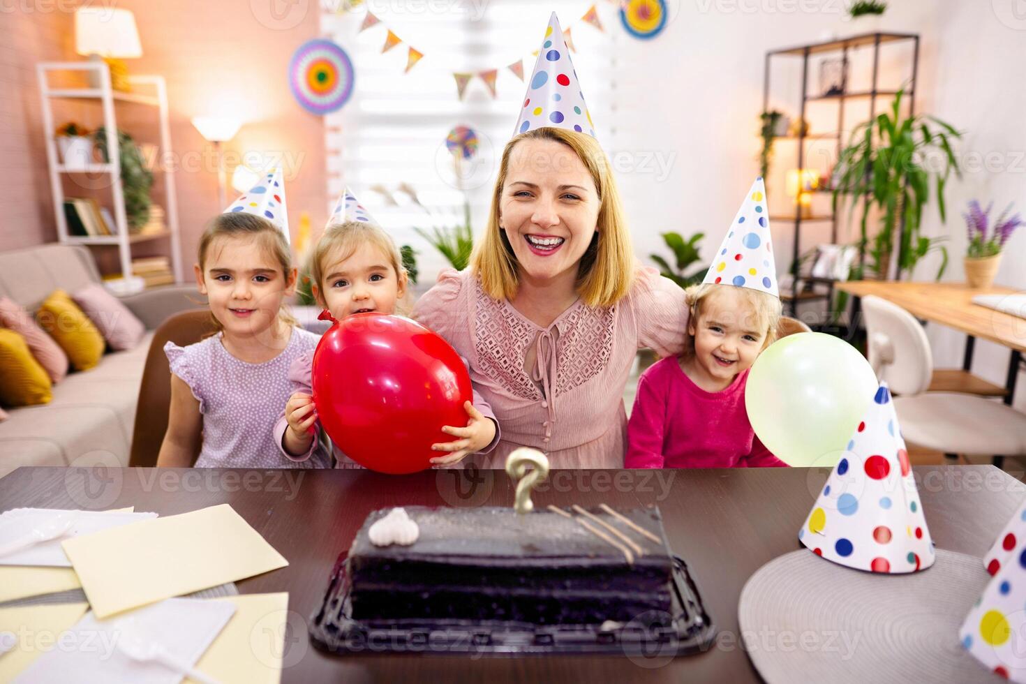 Joyful celebration with children and balloons in a cozy home photo