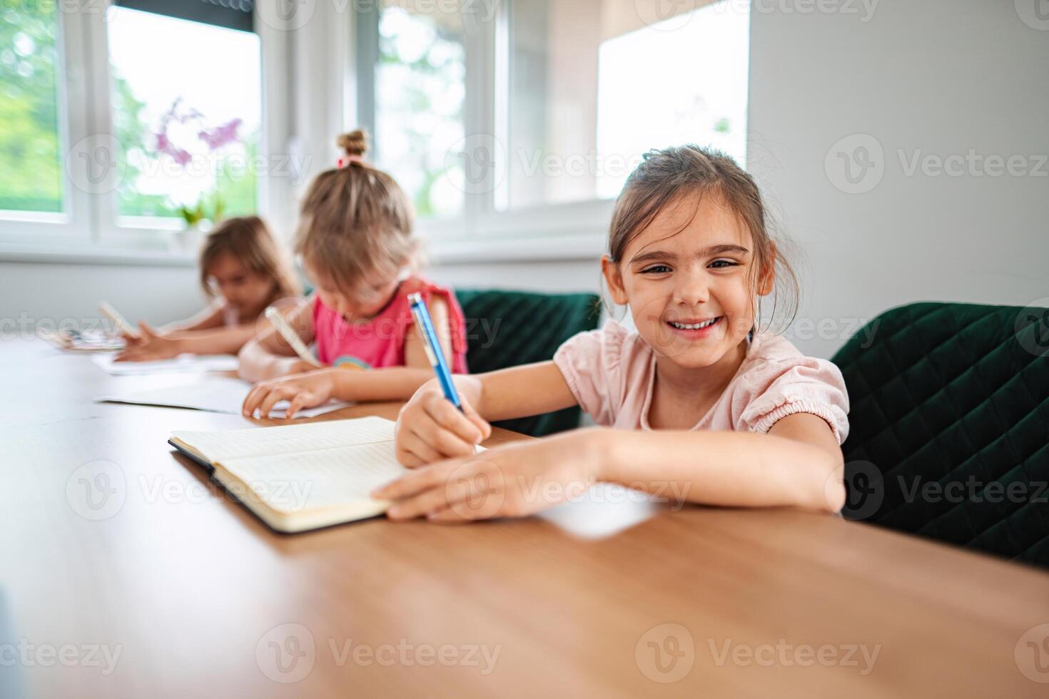 Young students engaging in creative learning at a table photo