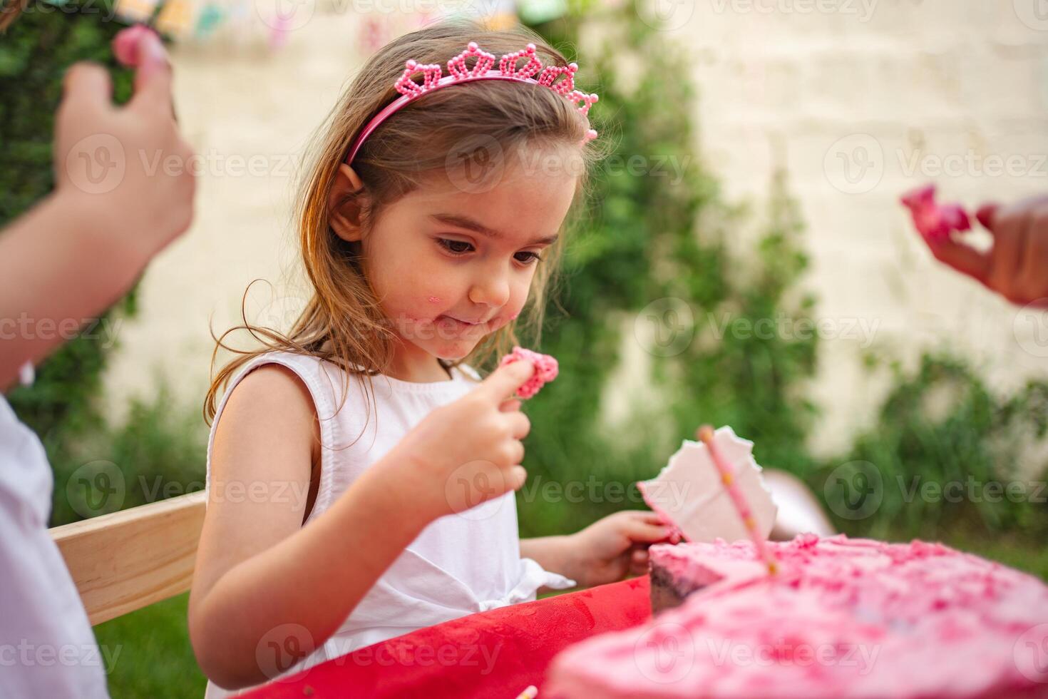Celebrating joy with pink cake at a cheerful gathering photo