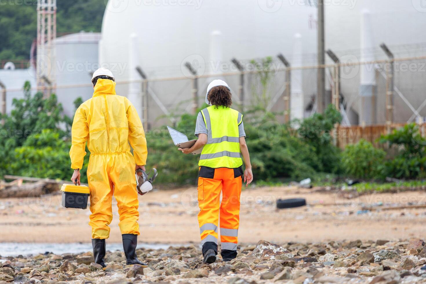 Environmental Workers Inspecting Industrial Site, Team in Protective Gear Surveying Contaminated Area, Engineers Assessing Safety at a Chemical Plant photo