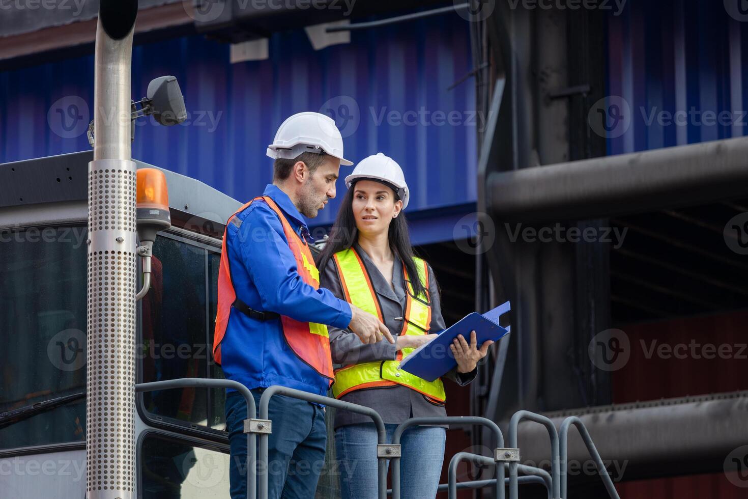 Inspectors team standing on top of a container handlers machine at container yard, Engineer and foreman worker inspecting containers box at shipping yard photo