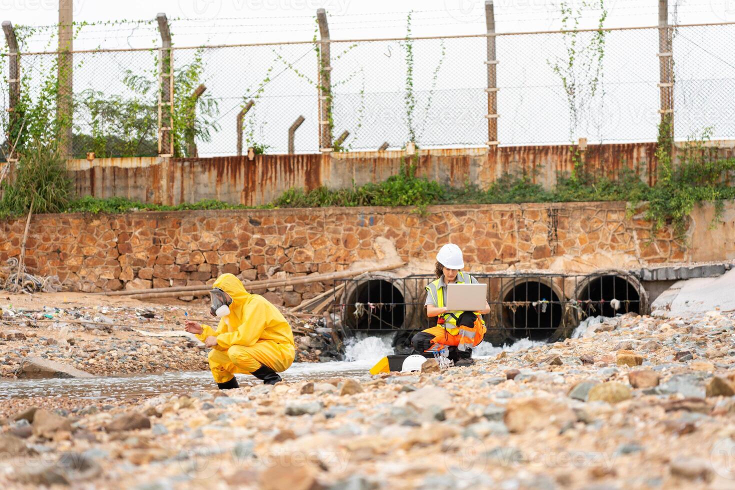 Workers Collecting Water Samples for Environmental Research, Engineers Analyzing Environmental Data on a Beach Cleanup Project, Environmental Engineer Conducting Field Work for Pollution Control photo