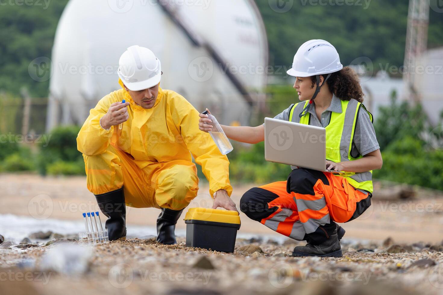 Environmental Engineers Conducting Field Work for Pollution Control, Workers Collecting Water Samples for Environmental Research, Engineers Analyzing Environmental Data on a Beach Cleanup Project photo
