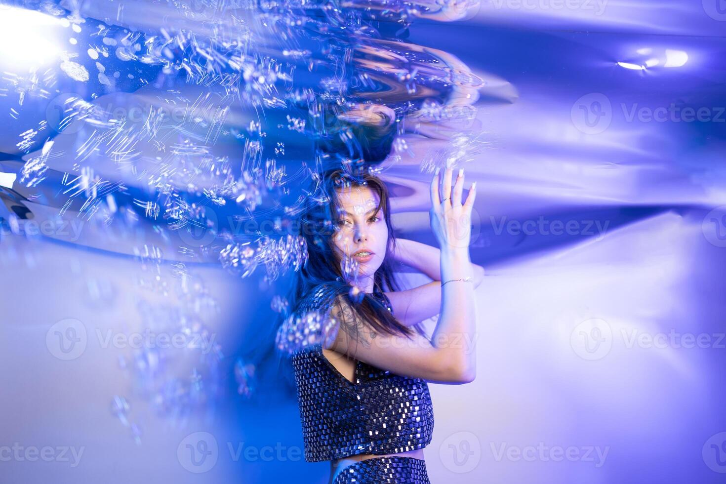Girl Embodies a Fabulous Mermaid in a Whimsical Underwater Setting Surrounded by Shimmering Bubbles photo