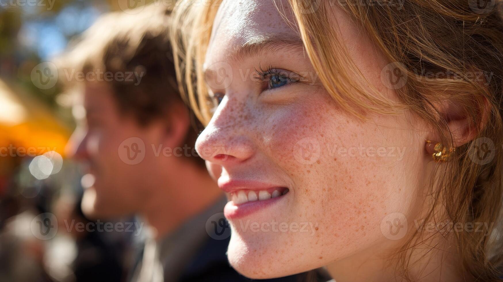 Closeup Portrait of a Freckled Young Woman Smiling Outdoors photo