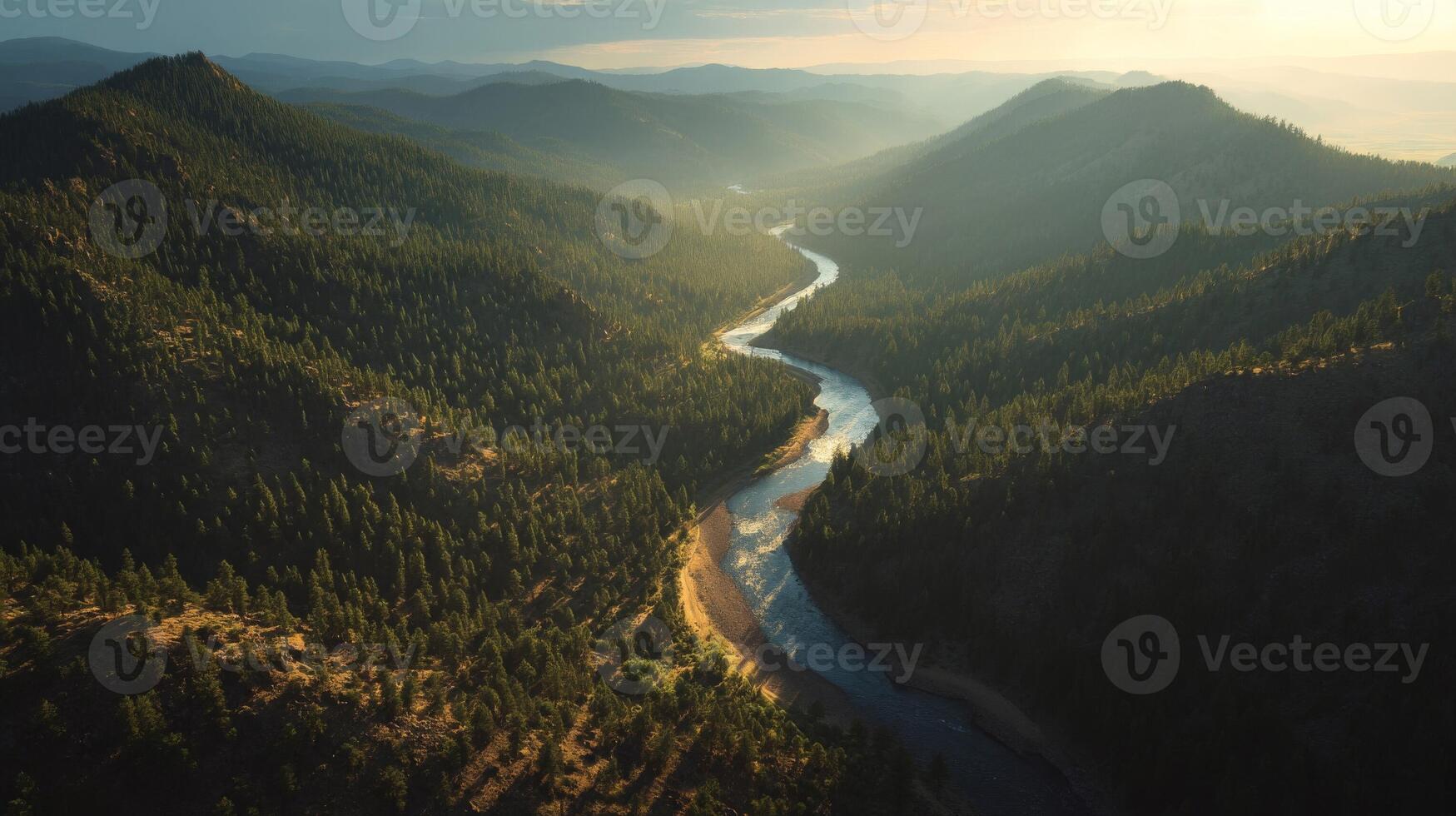 Aerial View of a Winding River Through a Mountain Valley at Sunset photo