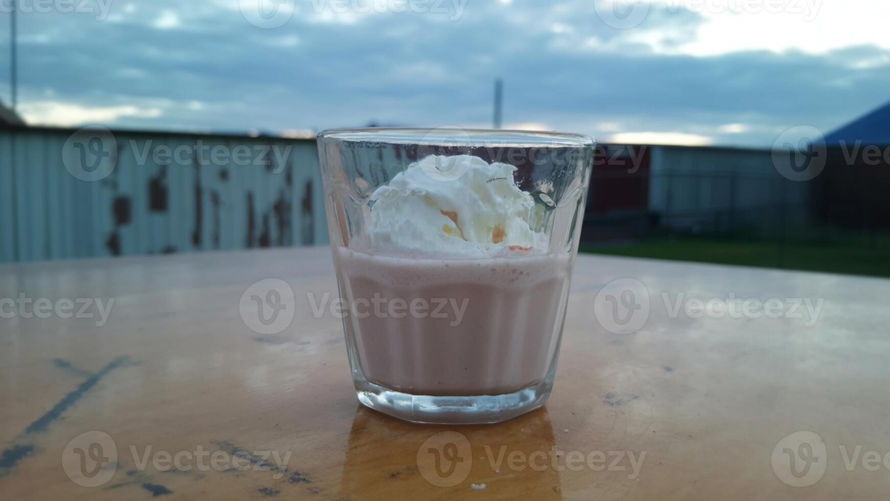 A glass of ice cream with whipped cream on top photo
