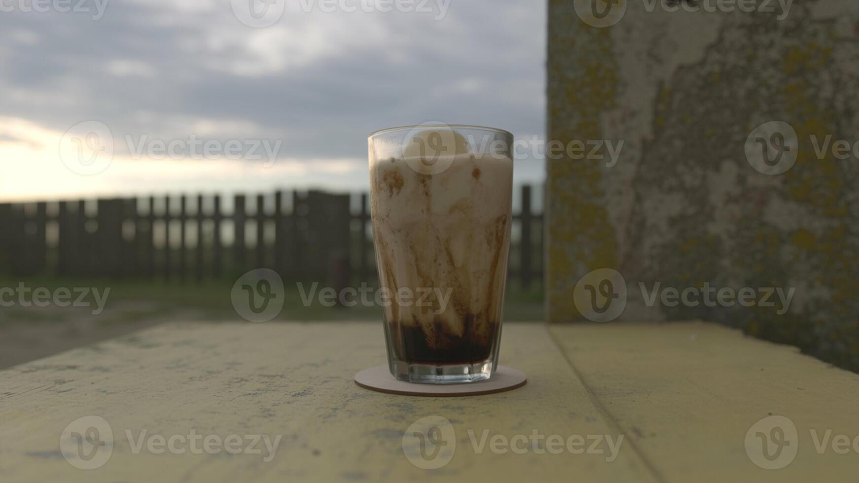 A glass of ice cream sitting on a table photo