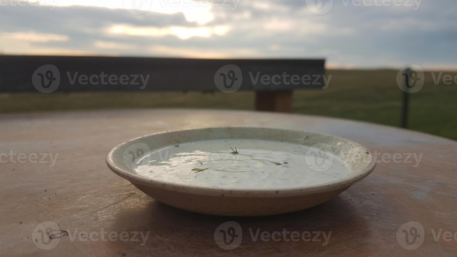 A bowl of soup sitting on a table photo