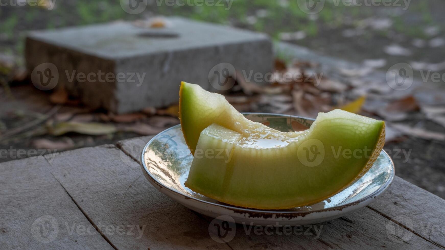 A half eaten melon sitting on a table photo