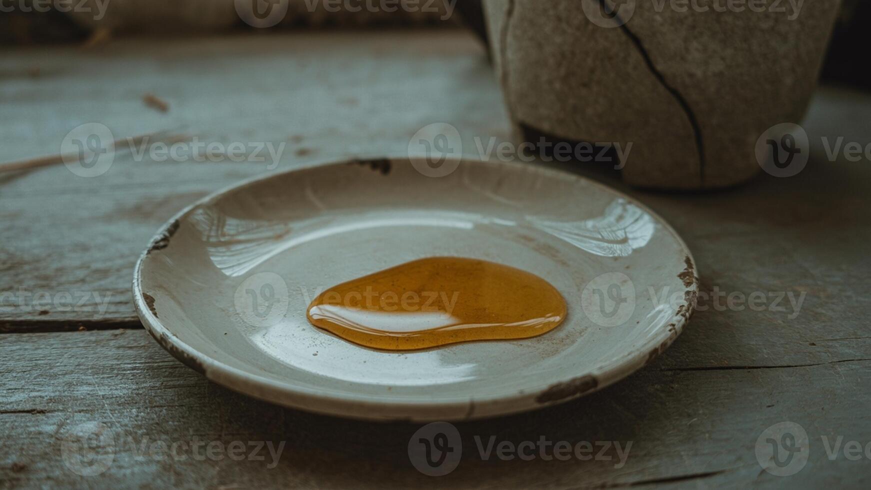 A bowl of honey sits on a table photo
