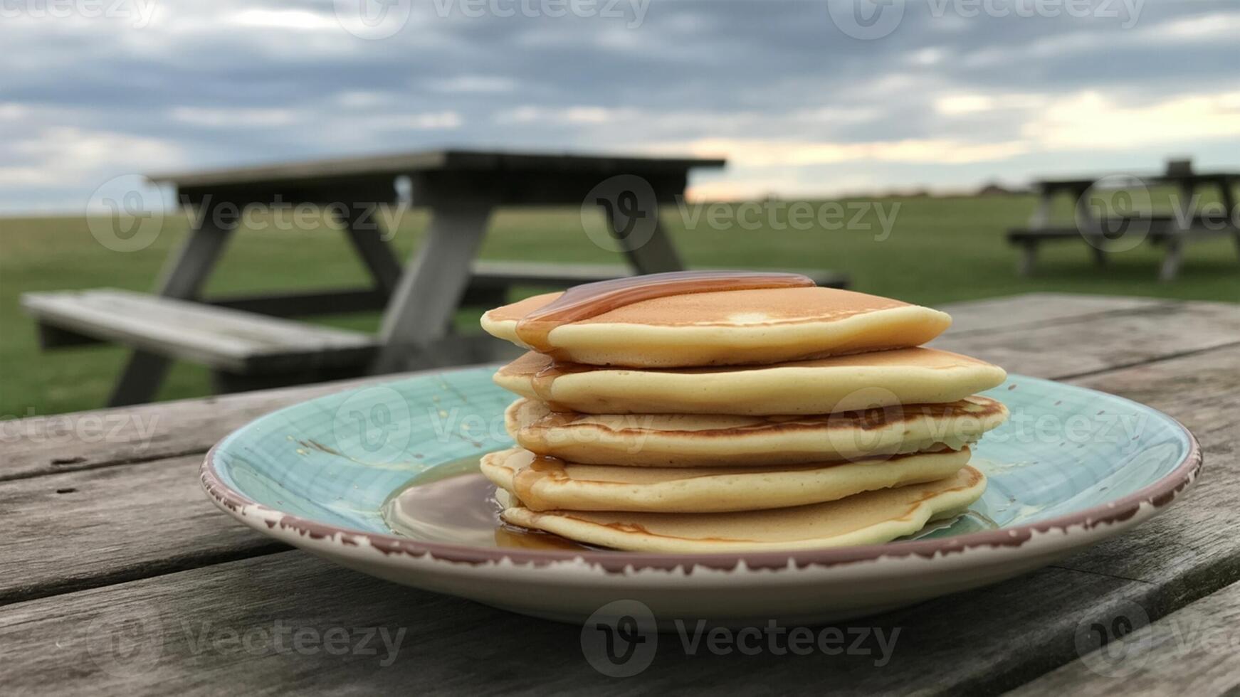 A stack of pancakes on a plate on a wooden table photo