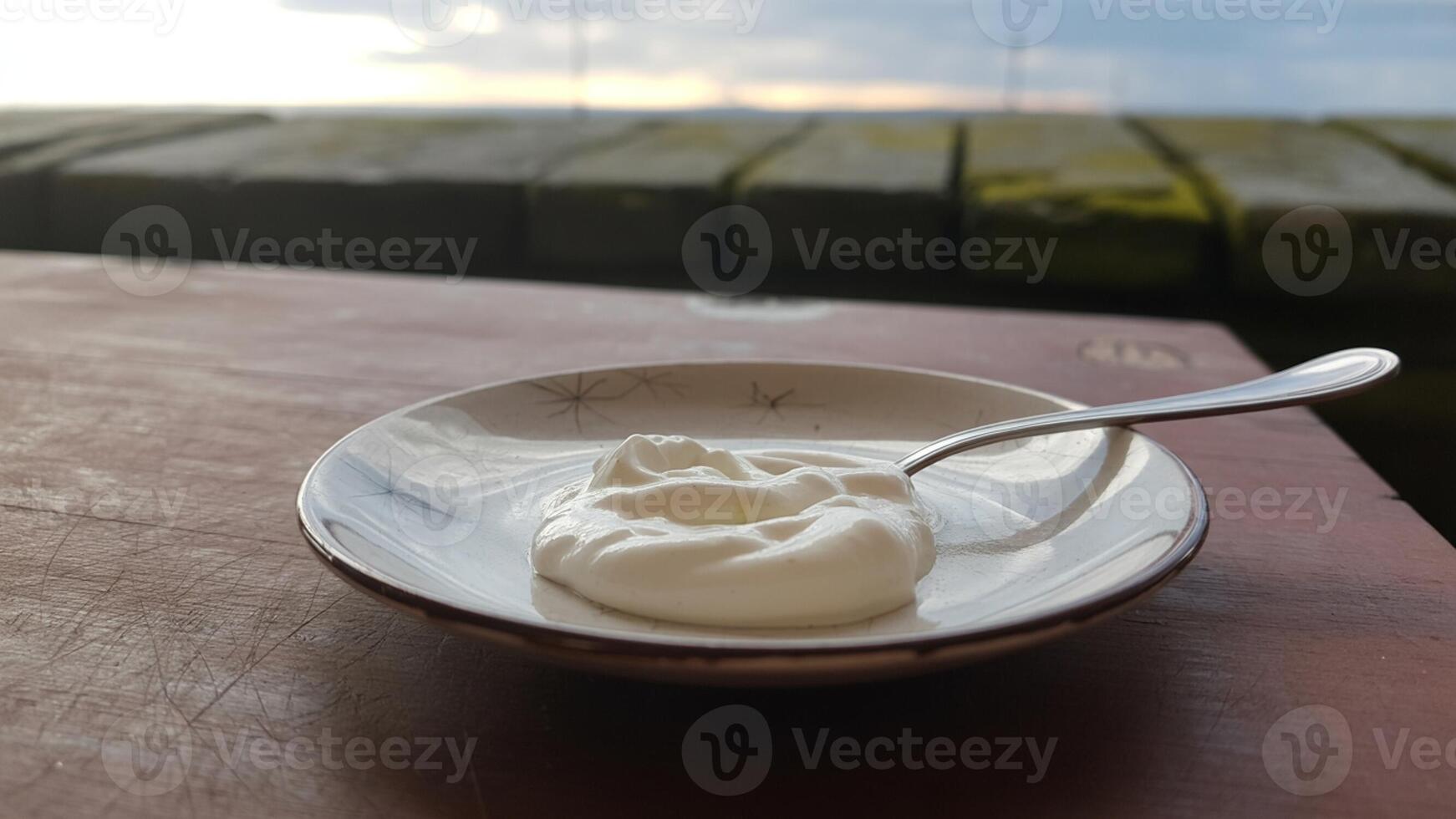 A bowl of yogurt on a table photo