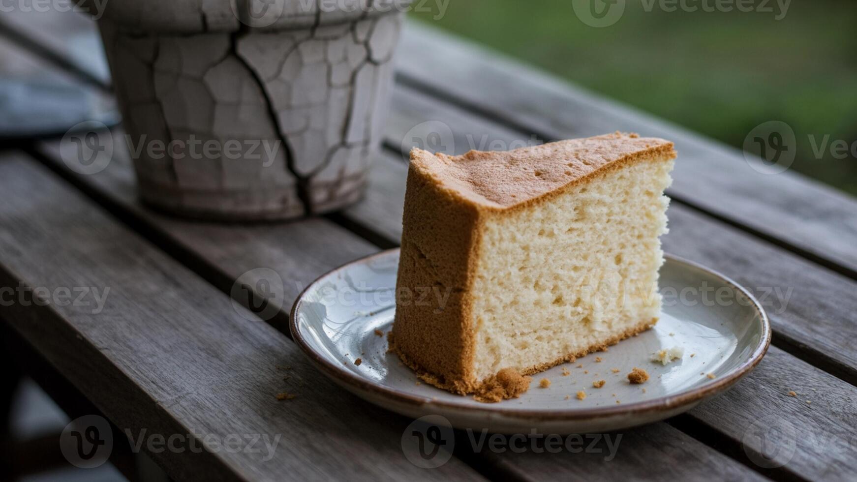 A slice of cake on a plate on a wooden table photo