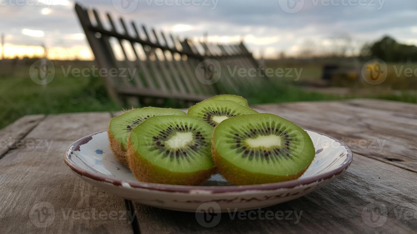 A bowl of kiwi fruit sitting on a table photo