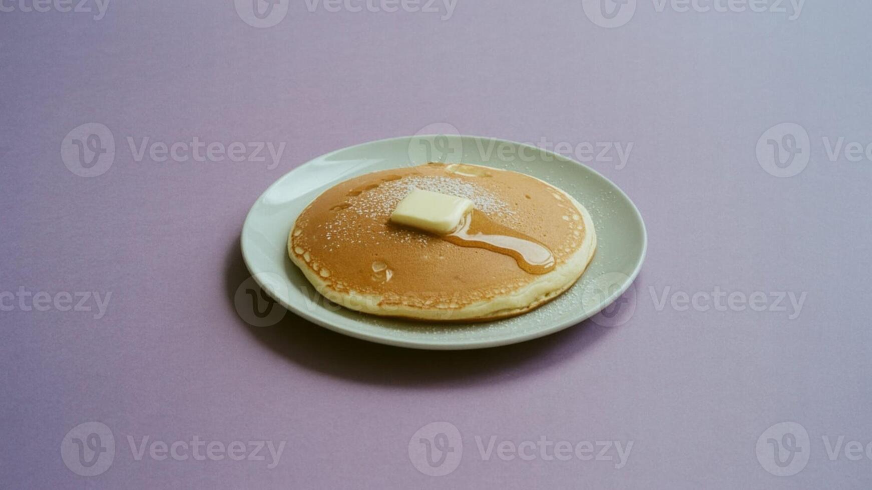 A single pancake on a plate with butter and syrup against a light purple background in a studio shot photo