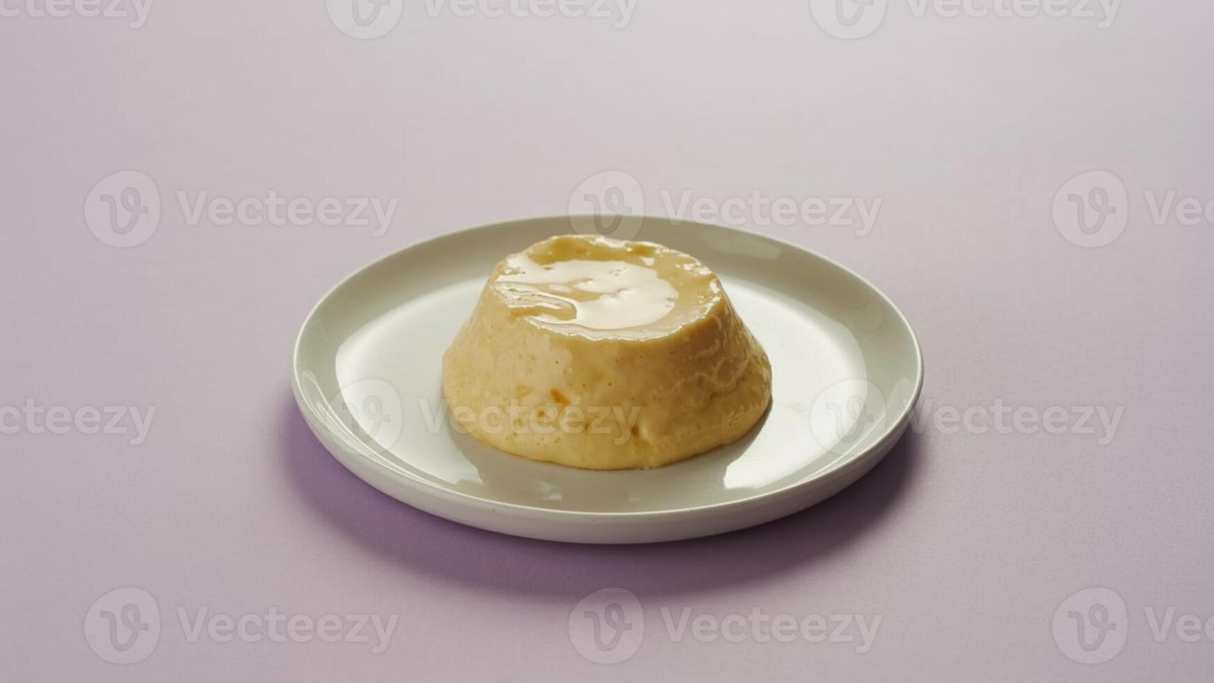 A caramel custard dessert on a white plate with a light purple background in a studio shot photo