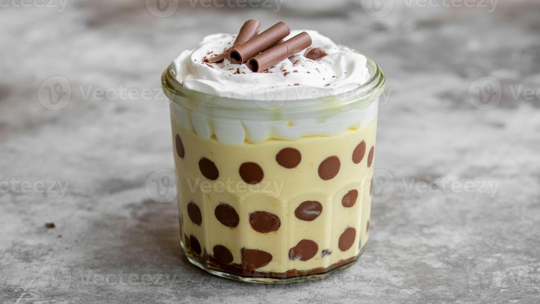 Close up of a chocola te dessert with stra wberry pieces on a white pla te on a neutra l surfa ce photo