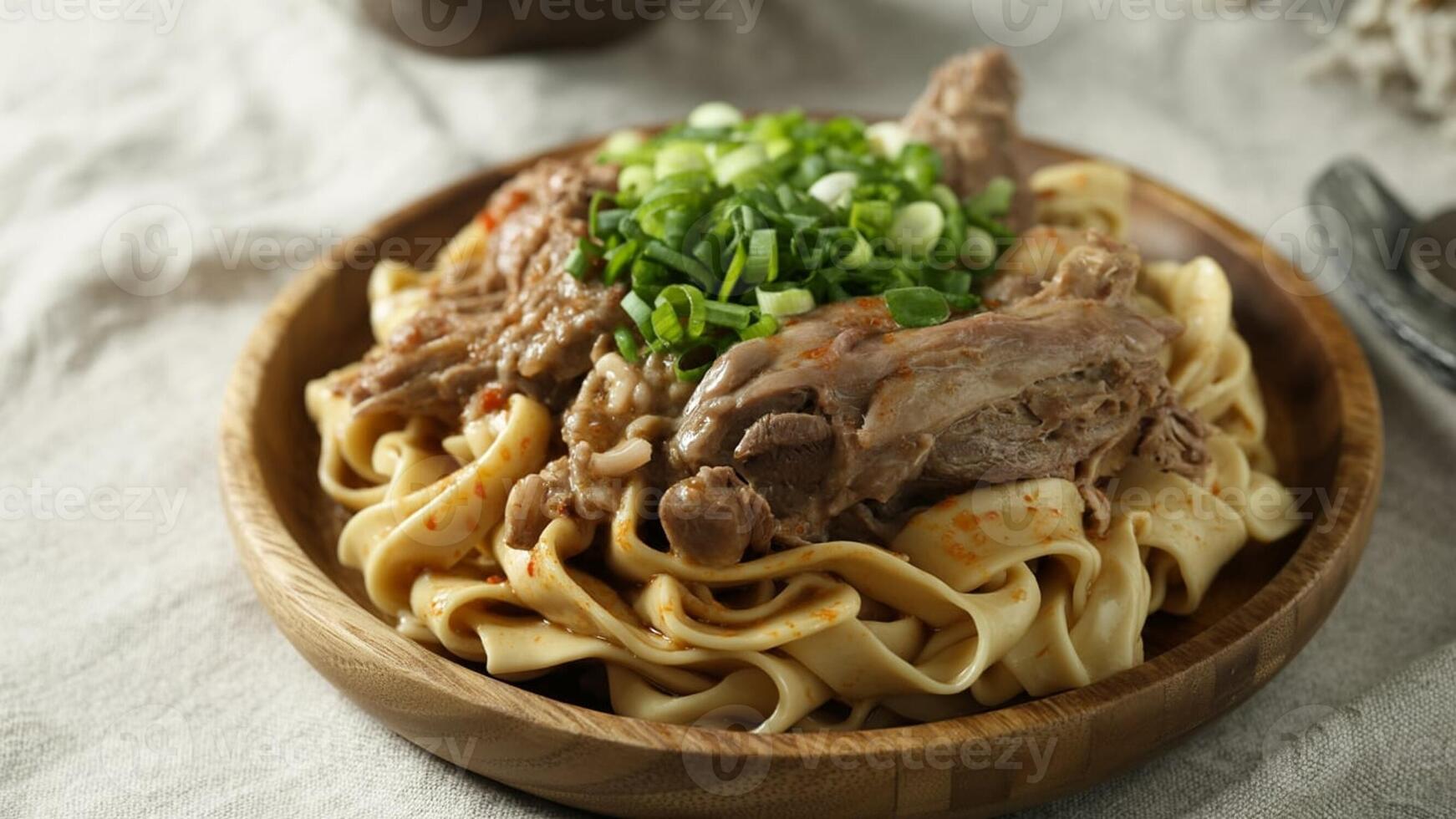 Close up shot of a bowl of lentil stew with mea t a nd vegeta bles on a wooden ta ble nea r a window photo
