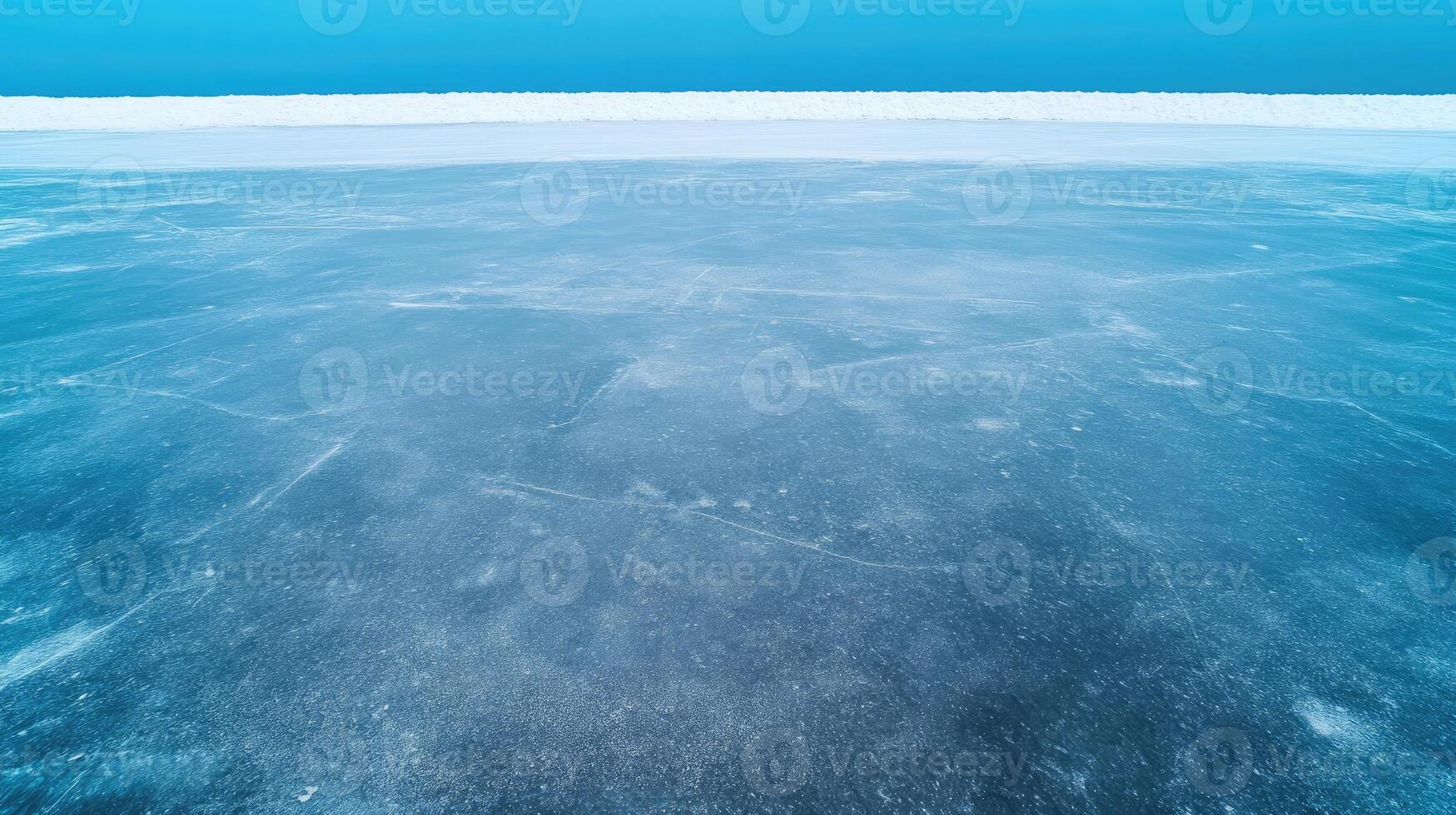 Clear and frozen lake surface under a blue sky is visible photo