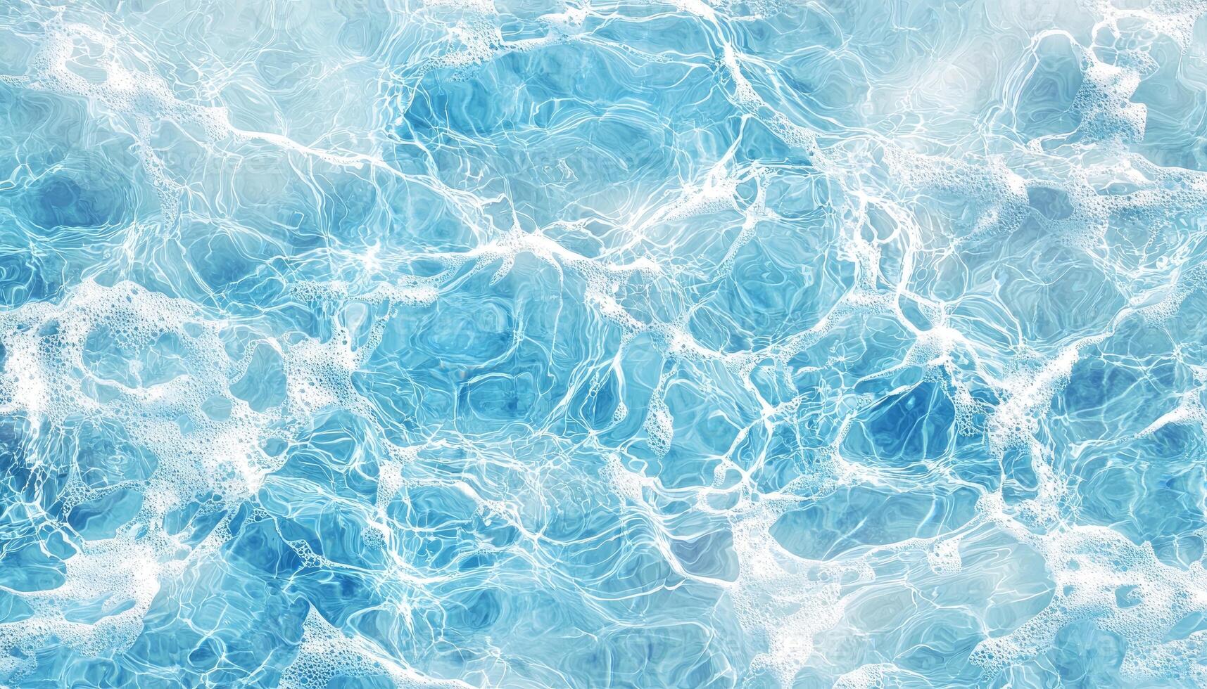 Clear blue ocean surface reflecting sunlight with gentle waves and bubbles photo