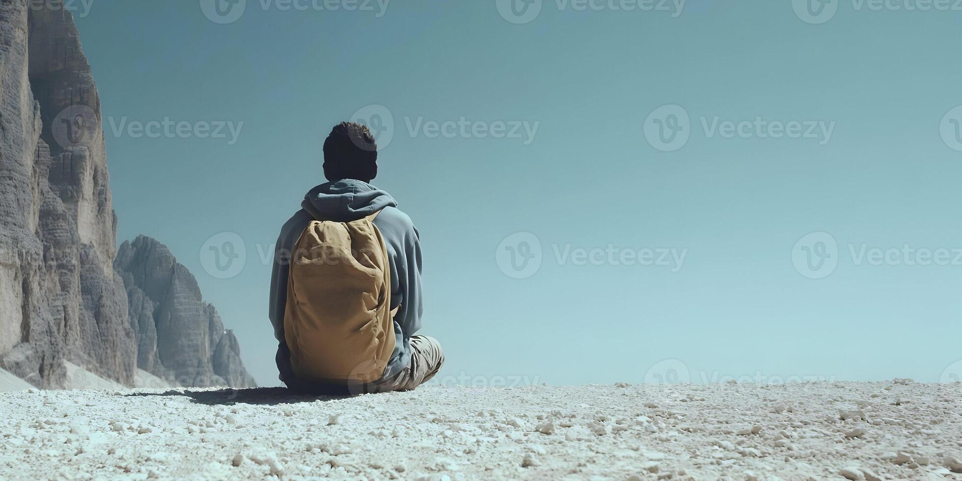 Person with Backpack Sitting on Mountaintop Scenic View photo