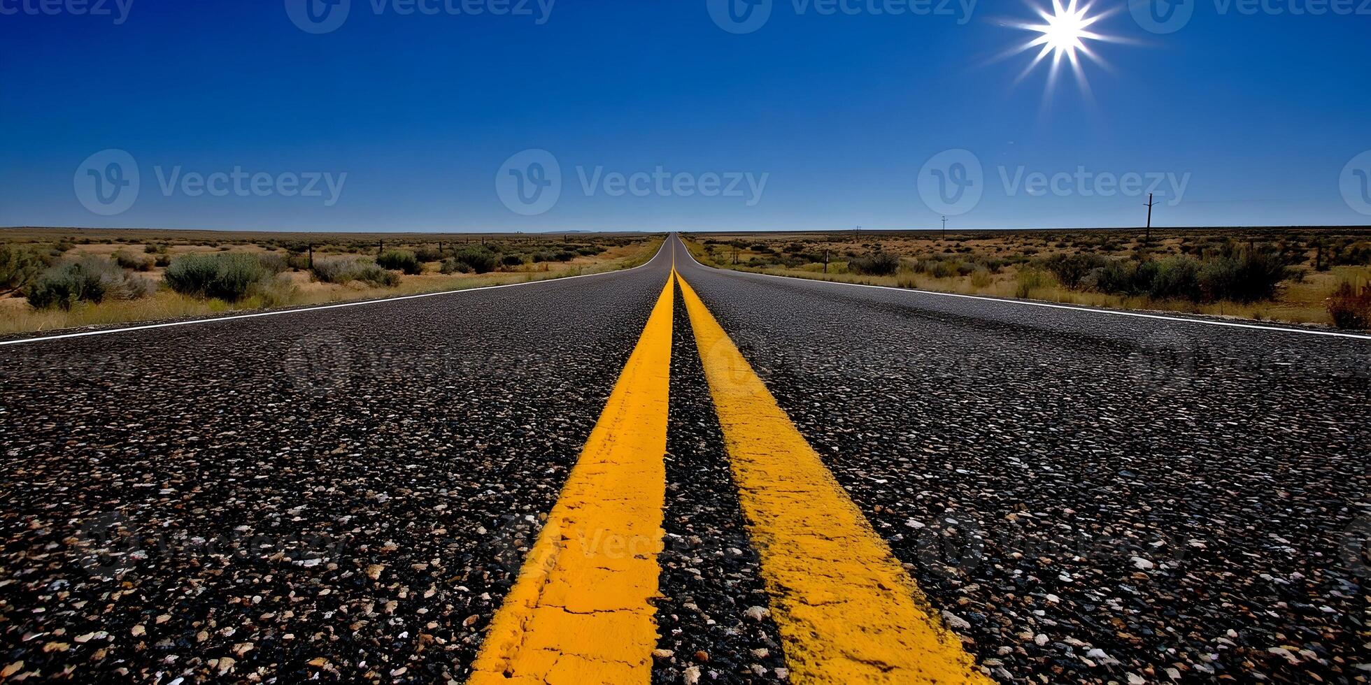 Asphalt Road Cutting Through Desert Under Bright Sun photo