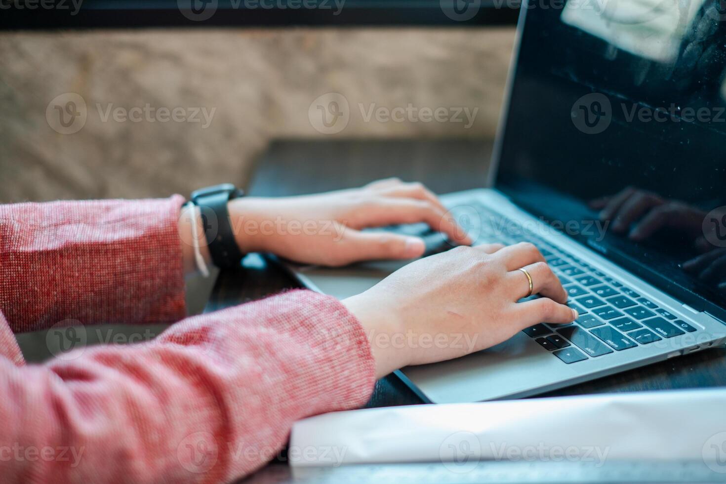 Hands typing on a laptop in a cozy workspace, showcasing modern technology and productivity. photo