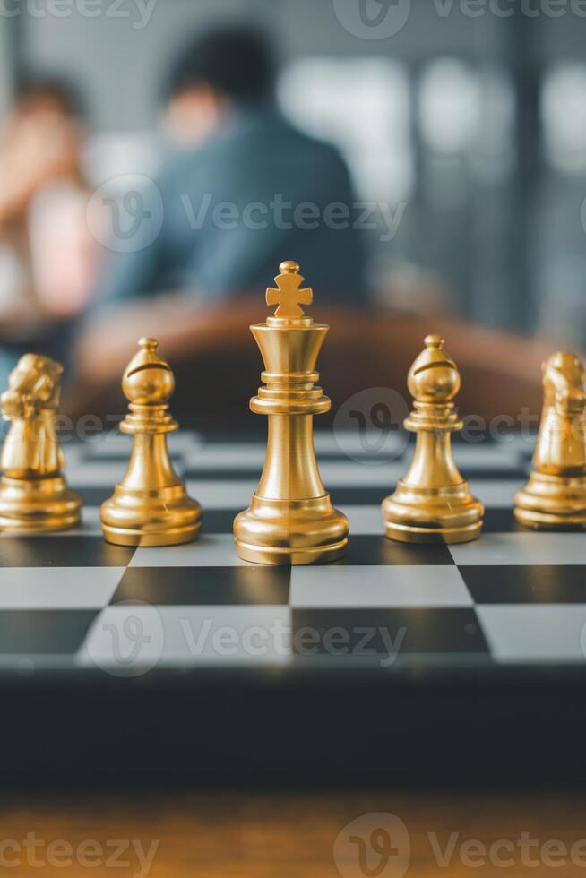 Close-up of gold chess pieces on a board, capturing a strategic moment in a contemporary environment. photo