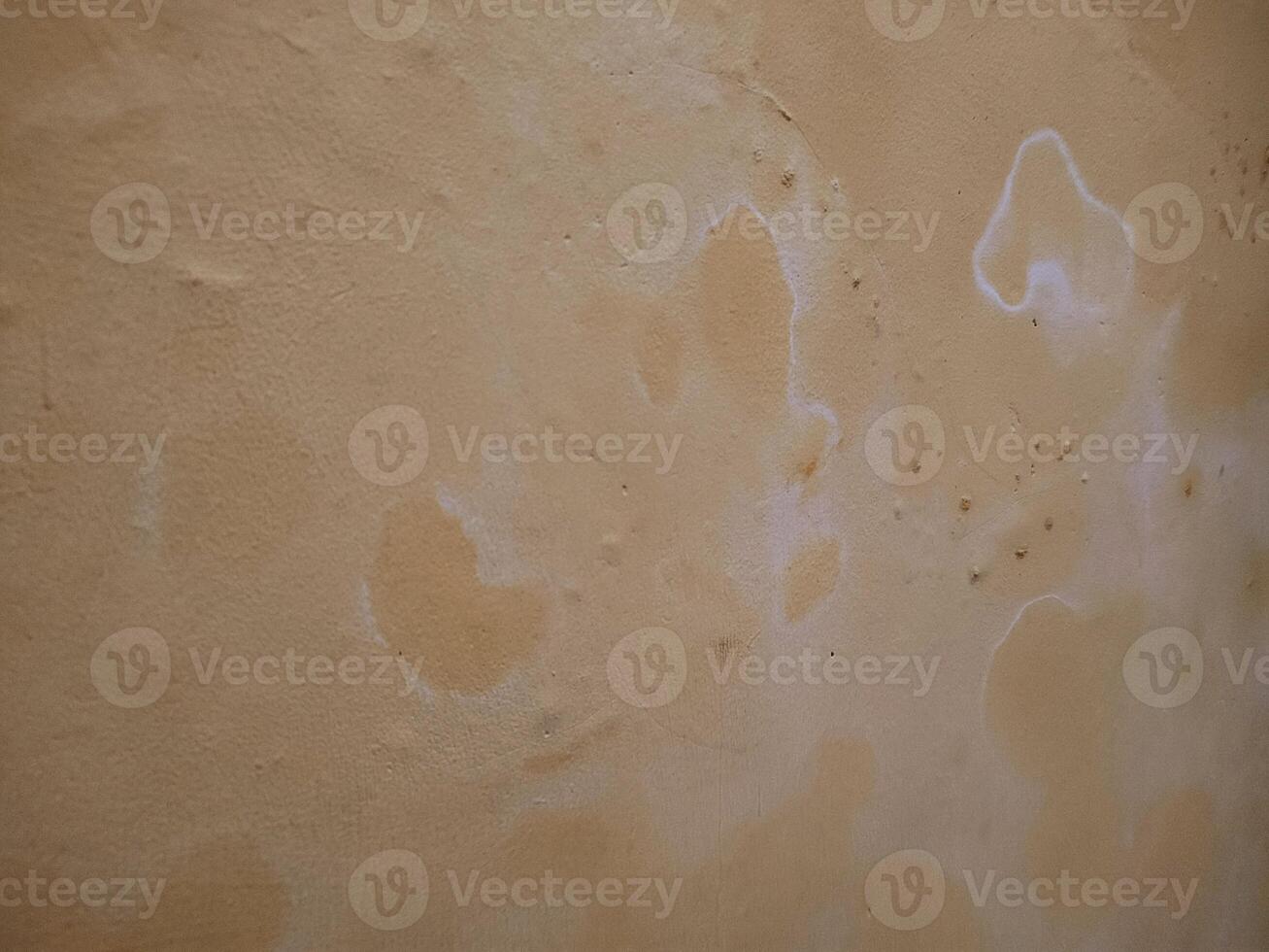 a wall with white paint on it and some stains photo