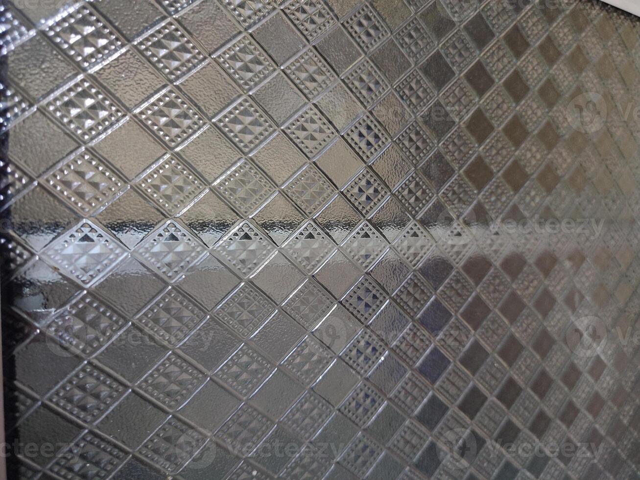 a glass wall with a pattern of squares and diamonds photo