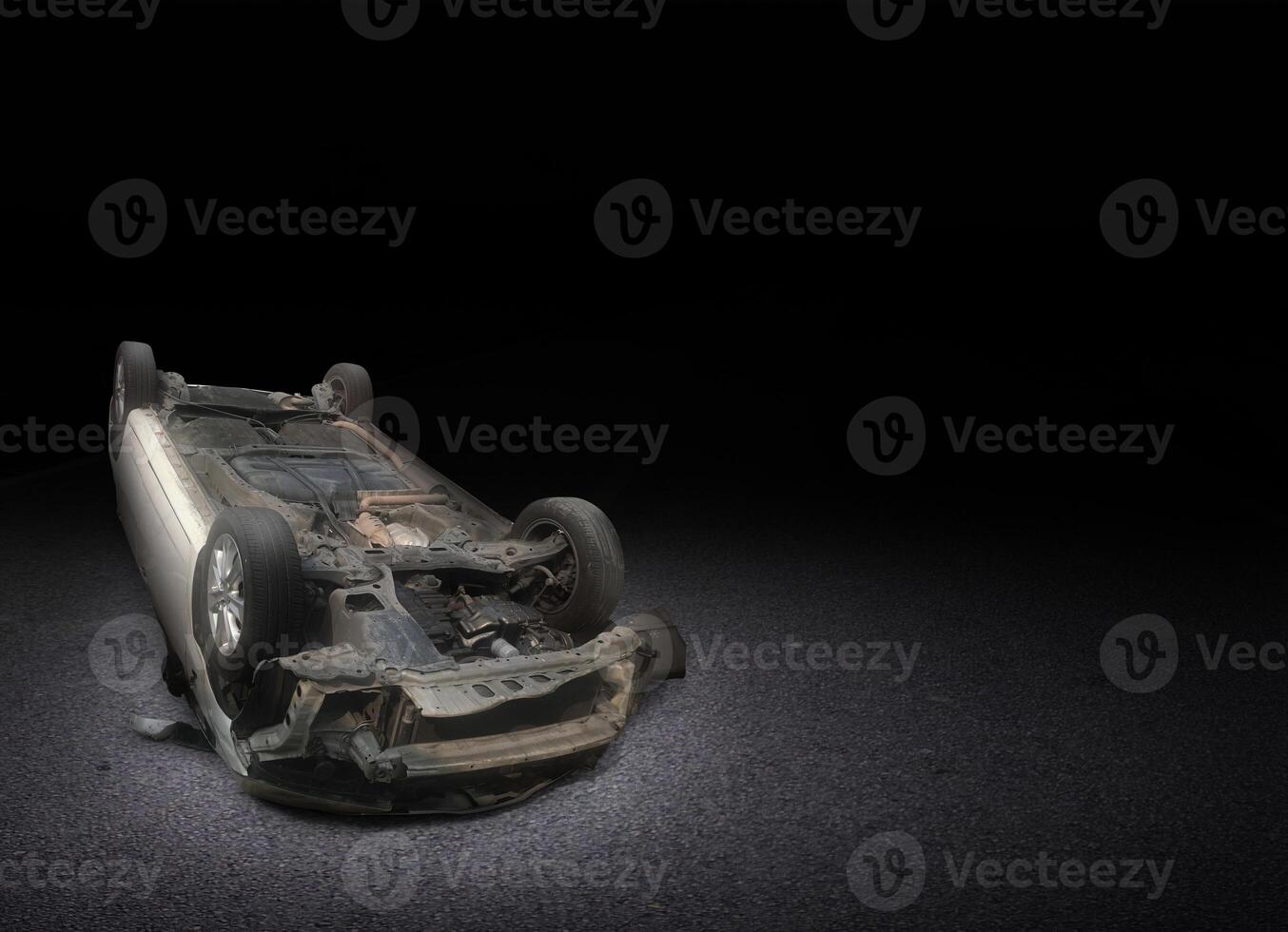 Car damaged after crashing and overturning on the road at night. Car accident. photo