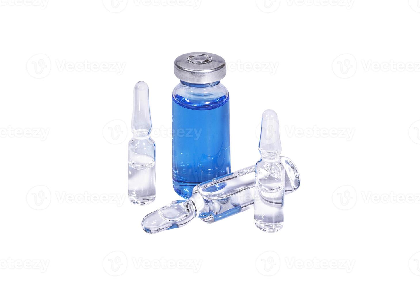 Medical vial with blue vaccine and ampoules on white background photo