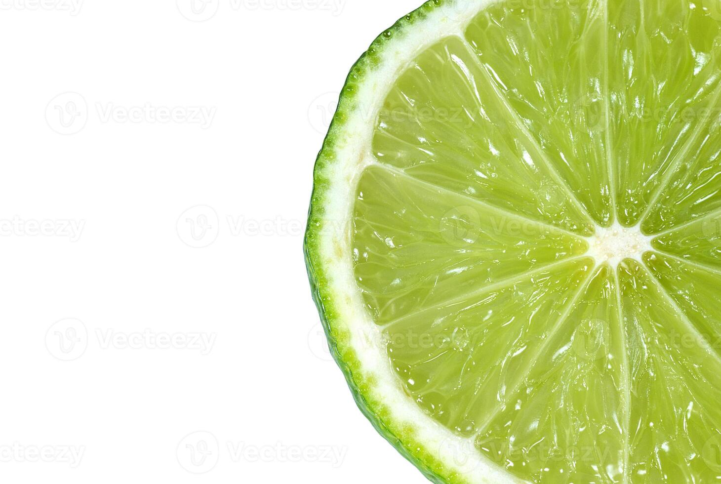 Juicy slice of lime citrus closeup on the white background photo