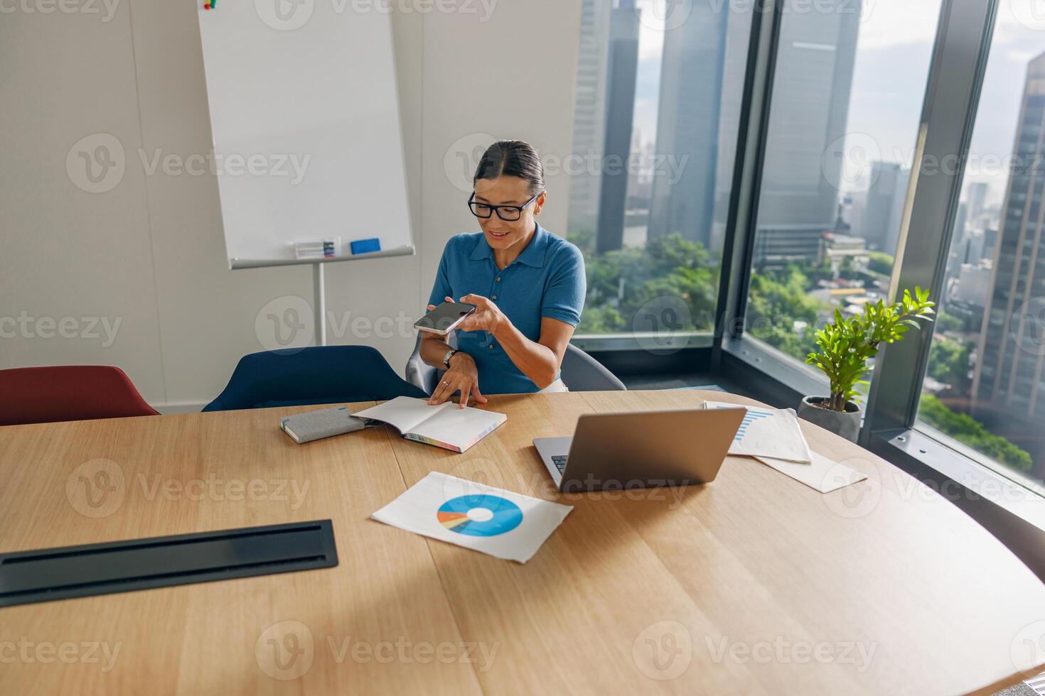A Professional Woman is Actively Engaged in a Modern Office Setting and Work Environment photo