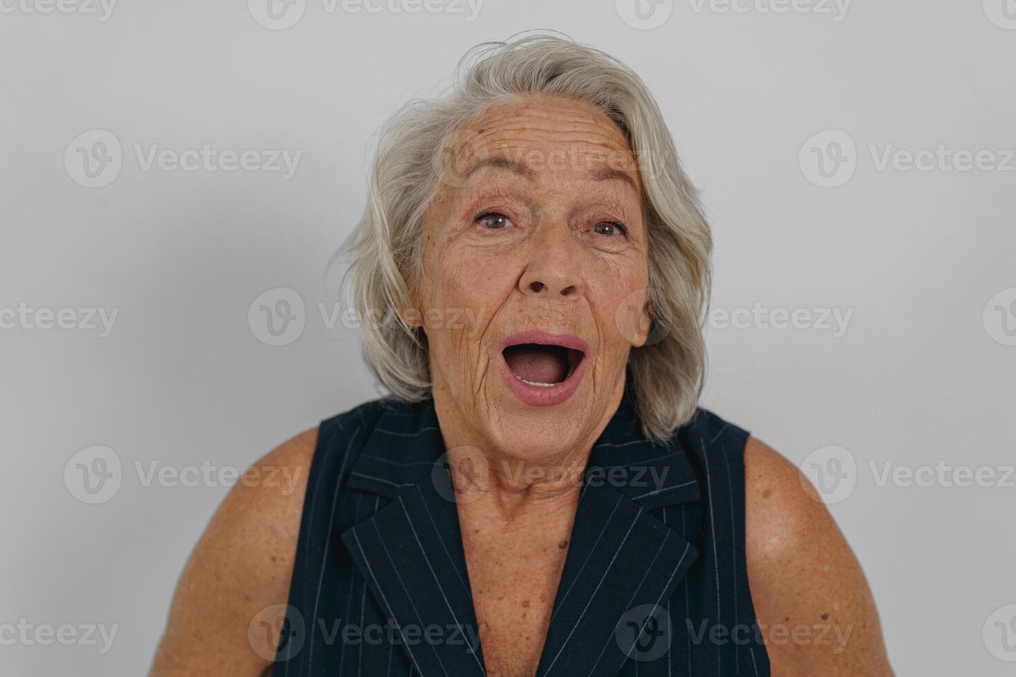 A Surprised Senior Woman Joyfully Expressing Her Delight and Happiness in a Candid Moment photo