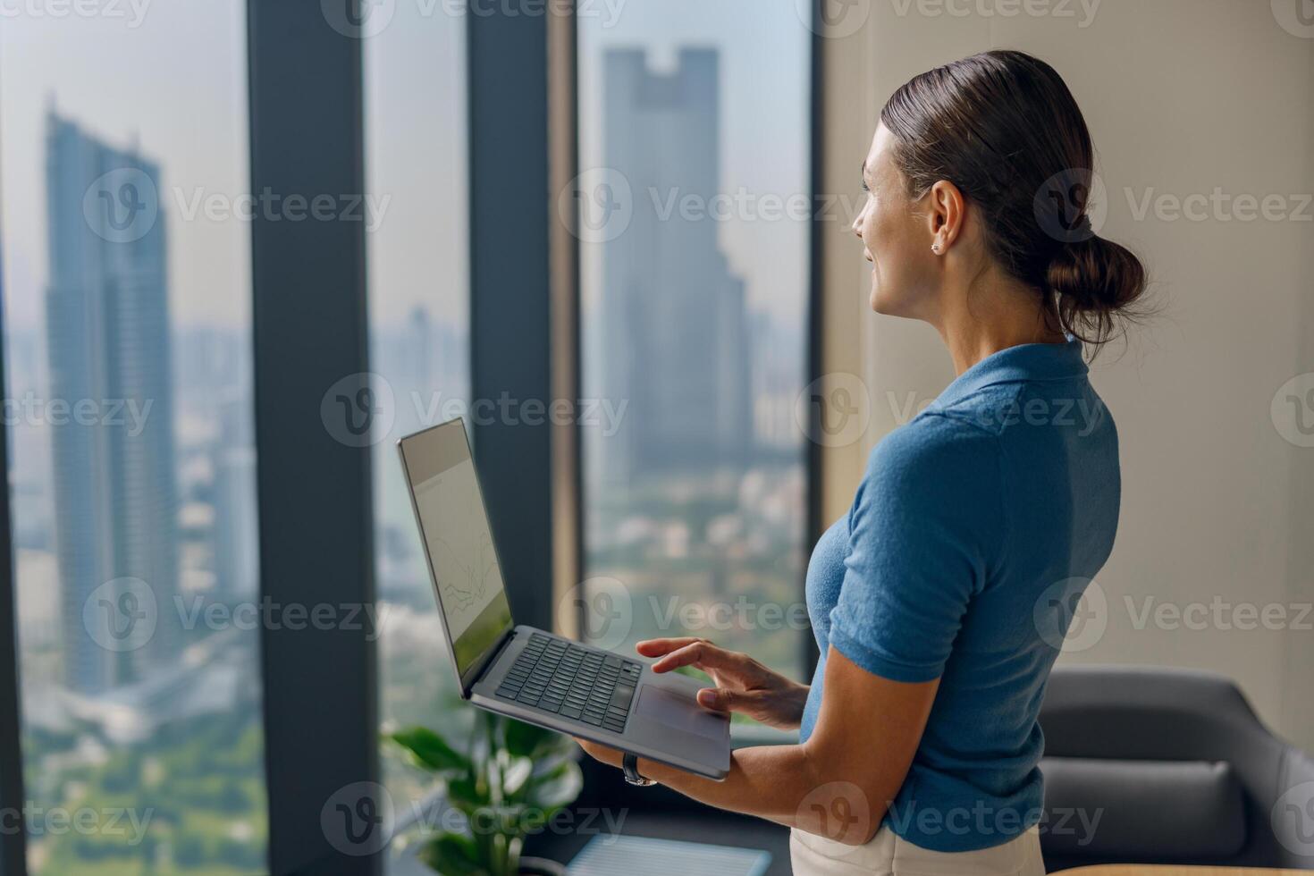 Dedicated and Focused Professional Engaging in Remote Work with an Inspiring City View photo