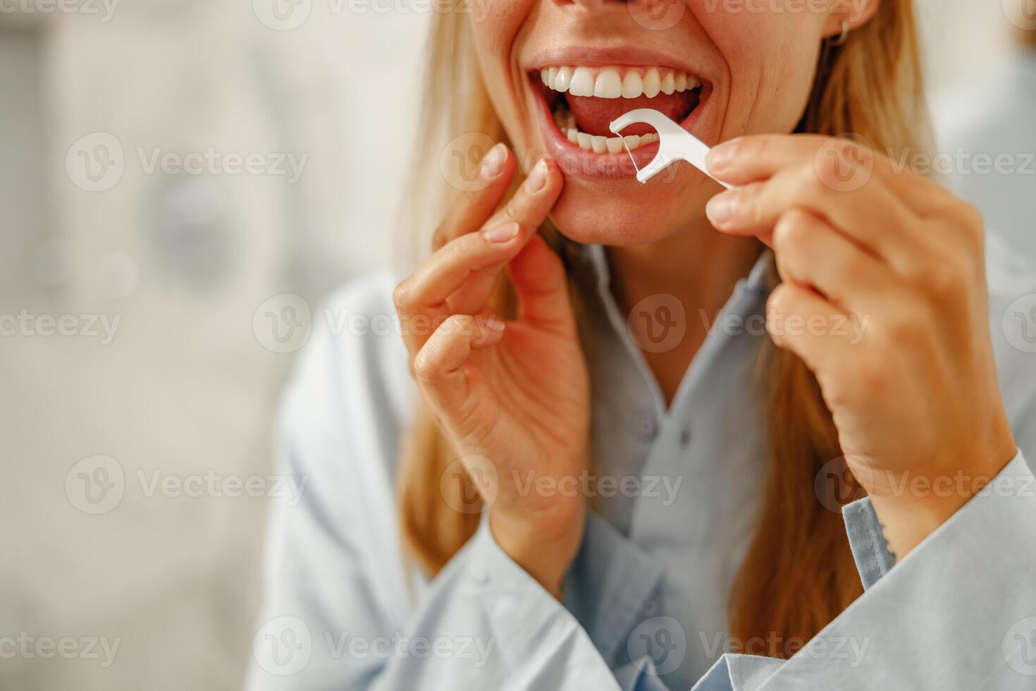 Flossing daily is vital for a beautiful smile and promoting overall health and hygiene photo