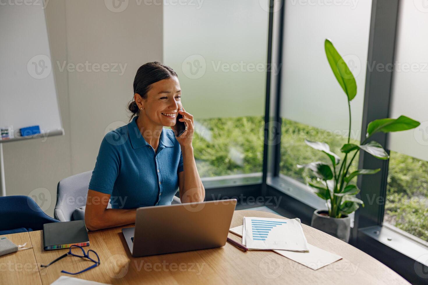 The Modern Office features a Businesswoman in Phone conversations in a Bright, inspiring Workspace photo