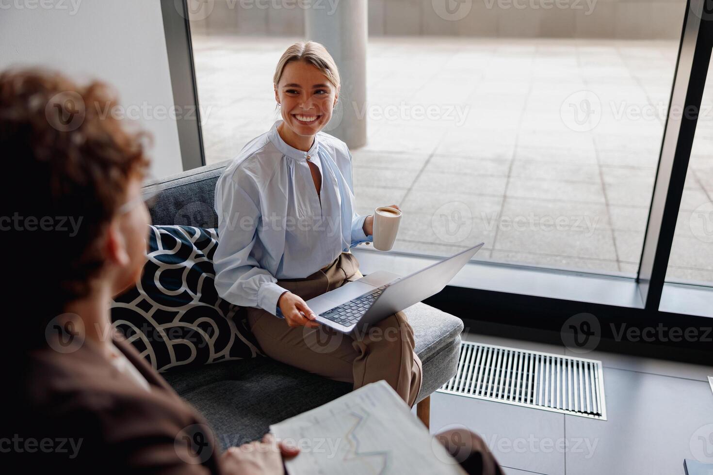 A business meeting occurs in a modern office setting with various professionals photo