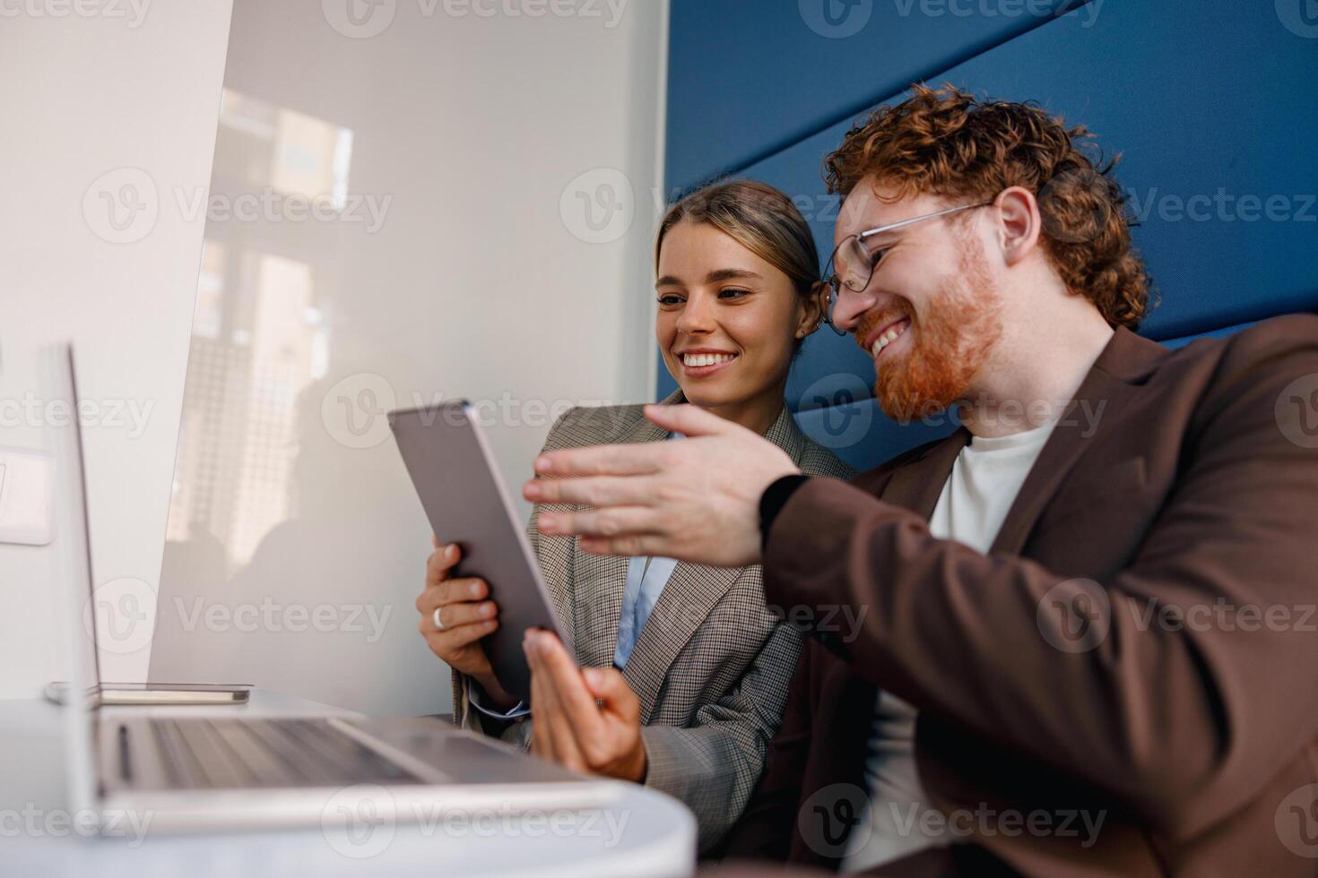 Engaged and dedicated colleagues are collaborating effectively on various digital devices photo